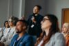Businessman,Asking,A,Question,During,A,Diverse,Conference,Workshop,Presentation.