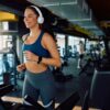 Happy,Athletic,Woman,Exercising,On,Treadmill,During,Sports,Training,In
